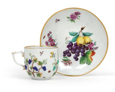 A cup and saucer moulded with grapes, - Works of Art