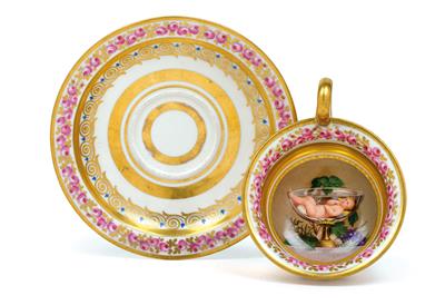 A tea cup with small bacchus, and saucer, - Works of Art