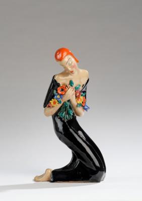 A female figure with flowers and twisted upper body in a squatting position, in the style of Ceramiche Lenci - Jugendstil and 20th Century Arts and Crafts