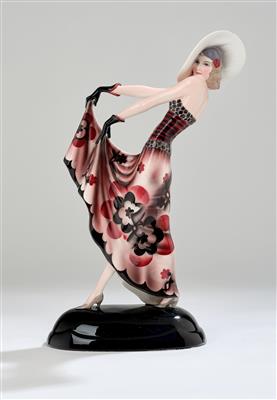 Stephan Dakon, a figurine “Blonder Traum” (Lilian Harvey as a striding lady with a large hat and gloves, lifting her dress with both hands) on an oval base, designed in c. 1932, executed by Wiener Manufaktur Friedrich Goldscheider, by c. 1941 - Jugendstil e arte applicata del XX secolo