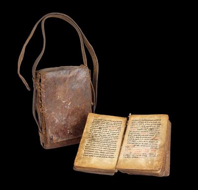 Ethiopia: An old ‘Bible’ of the Ethiopian Christian Church. Handwriting on parchment. In a leather sleeve with straps. - Tribal Art