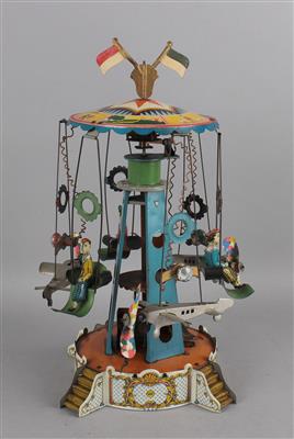 Karussell aus Blech, mit Uhrwerk und Beleuchtung, um 1930. - Spielzeug