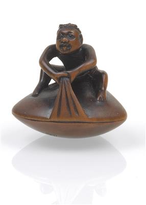 A boxwood netsuke of a man on a clam - Asian art